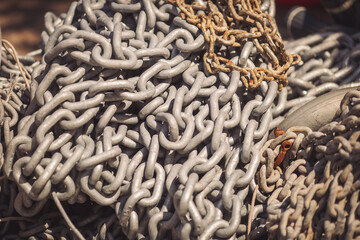 Iron chains piled in a pile. pile of heavy metal chain, marine anchor chains. background chain rusty link streel. 