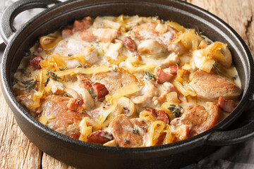 Creamy Pork Tenderloin Medallions with onions, bacon and mushrooms closeup on the plate on the table. Horizontal