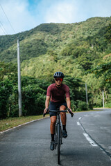 A woman cycling alone in the mountains.