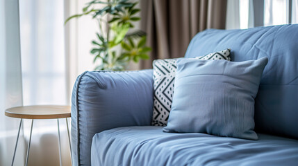 Elegant blue sofa with decorative pillows in a bright interior