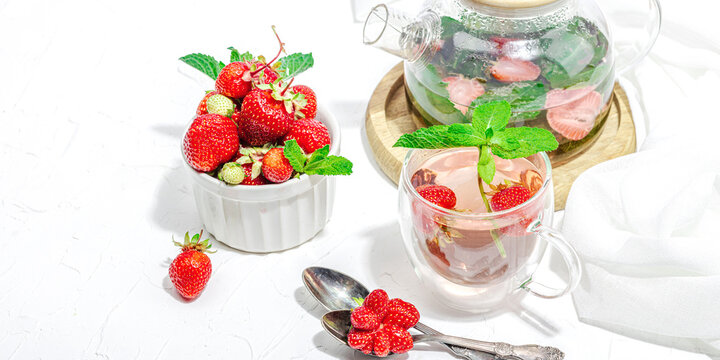 Strawberry tea concept. Good morning concept. Teapot, ripe fruits, healthy beverage
