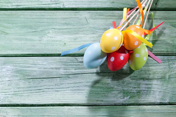 Coloured Easter eggs with polka-dots on green wood