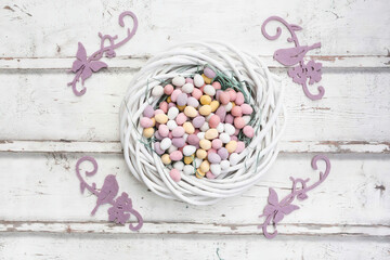 Color Easter eggs in white wicker basket