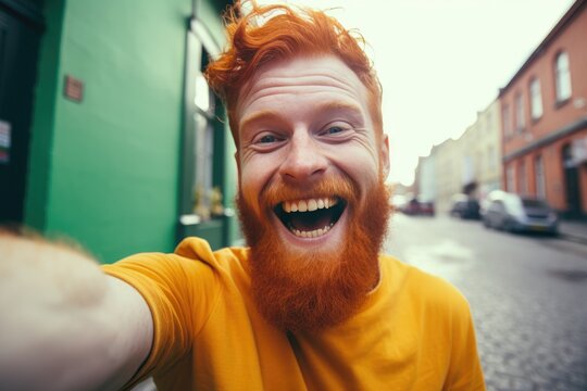 Photo of positive cheerful man with ginger beard dressed green t-shirt making selfie recording video isolated on green color background