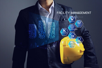 Facility manager holding yellow helmet to inspection and monitoring facility management work in...