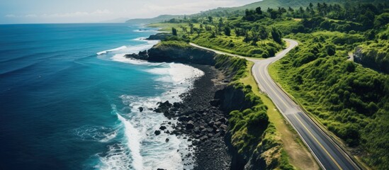 Aerial View of Scenic Coastal Road Amidst Cliffs and Lush Green Forest on Pandawa Beach Bali