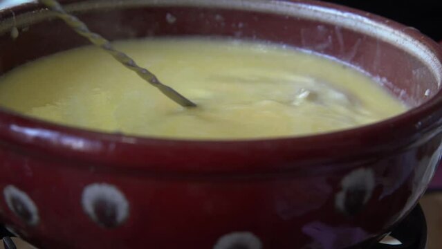 Swiss fondue made of white wine, dipping slices of Japanese beef stake and French bread.