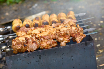 Marinated meat on skewers, grilled over hot coals