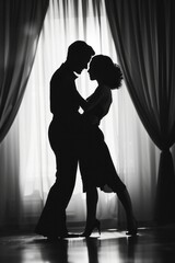 A man and a woman are gracefully dancing in front of elegant curtains. The couple moves in sync,...