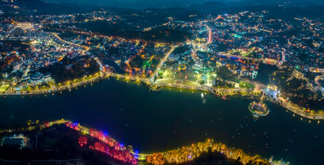 Da Lat, Vietnam - February 21st, 2024: Da Lat city night with urban areas, markets, sparkling...