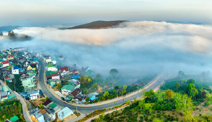Aerial view of the Cau Dat suburbs near Da Lat city at morning with misty sky in Vietnam highlands....