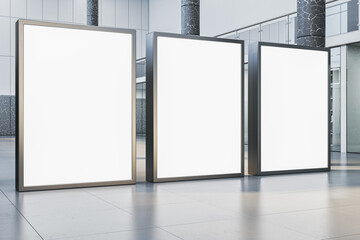 Contemporary empty white banners in interior with glass partitions, columns and concrete flooring....