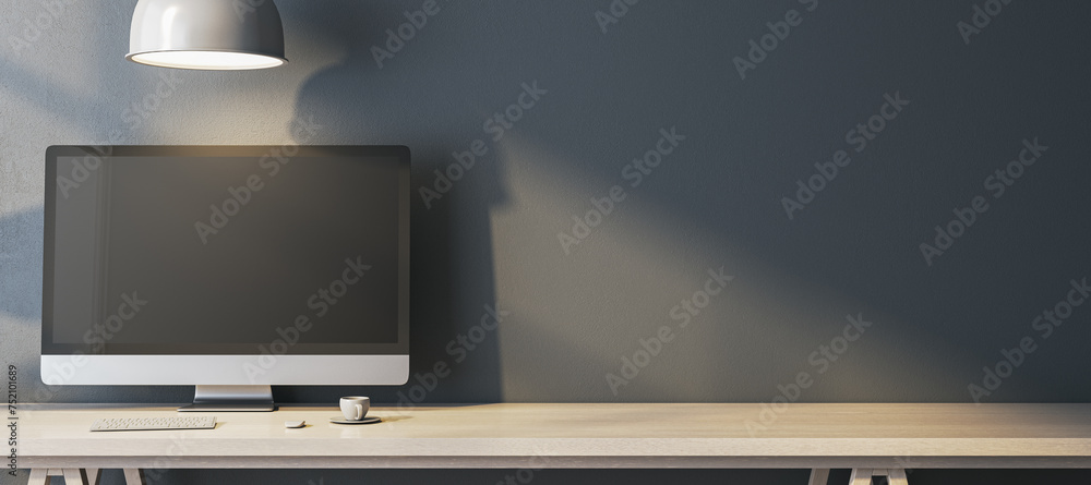 Poster Wide home office interior with empty computer monitor on designer desktop. Concrete wall background with shadows. 3D Rendering.