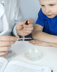 Child chemist. Teacher shows a visual experiment. A science mentor teaches an experimental...