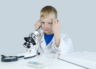 Child chemist. Teacher shows a visual experiment. A science mentor teaches an experimental...