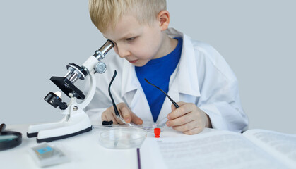 Child chemist. Teacher shows a visual experiment. A science mentor teaches an experimental...