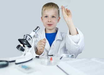 Child chemist. Teacher shows a visual experiment. A science mentor teaches an experimental...