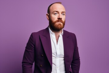 Portrait of a handsome red-bearded man in a purple jacket.