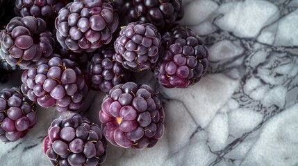 Blackberries and raspberries on the marble countertop, table, fresh