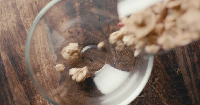 Muesli cereal granola oats poured in cup breakfast top down close up