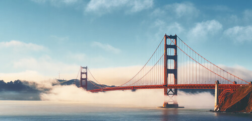 a bridge with fog rising from the water and fog rolling in the air behind it and a mountain in the distance, generative ai