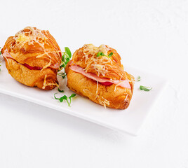 Fresh croissants stuffed with ham and cheese