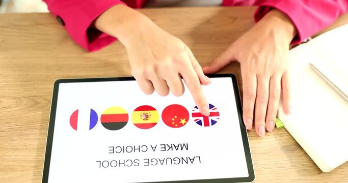 Tablet screen with app learning different languages in language school remotely. Learning languages with a dedicated app concept