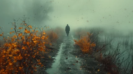 Zelfklevend Fotobehang A person strolling through a foggy landscape surrounded by grass and mist © Наталья Игнатенко