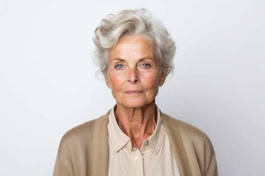 Portrait of a senior woman with wrinkles on her face, isolated on white background