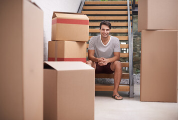 Man, moving and portrait in new house by stairs with boxes, fresh start or investment in real...
