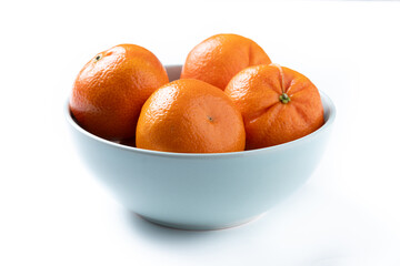 Fresh tangerines in bowl isolated on white background