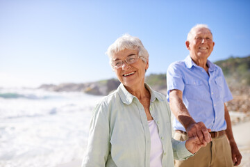 Elderly, couple and walk on beach for portrait on retirement vacation or anniversary to relax with...