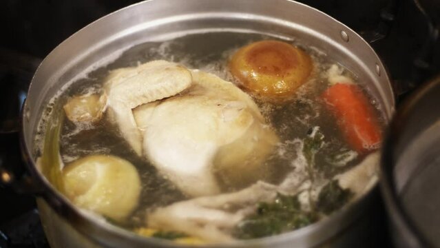 Boil the chicken broth with bouillon including apple, carrot, garlic, ginger, onion, and celery into water boiling in the big pot.