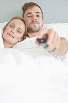 Couple in Bed Watching TV
