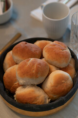 Authentic home made pastry buns made for birthday guests served in modern breadbasket
