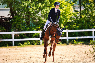 Horse show jumping horse with rider woman over the jump during a test in the show jumping...