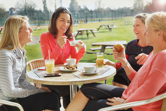 Women Having Breakfast at Outdoor Cafe

