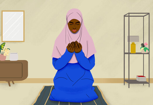 Muslim woman praying on mat in living room at home
