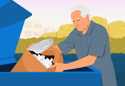 Senior man recycling plastic in industrial garbage bin
