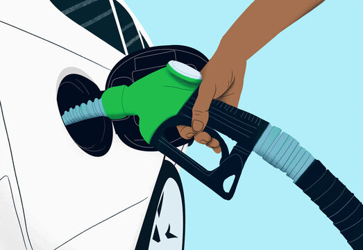 Close up hand holding green biofuel gas pump, refueling car
