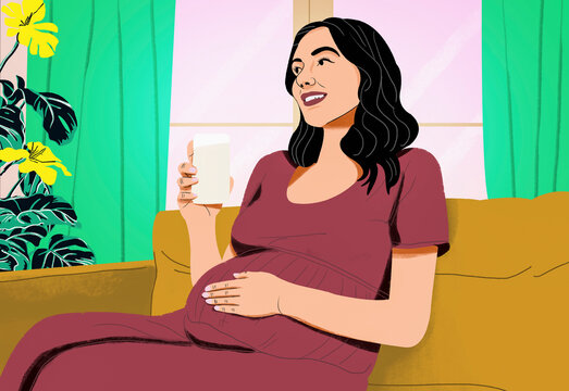 Happy pregnant woman drinking water on living room sofa
