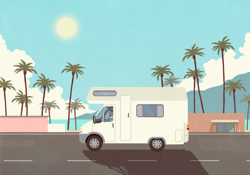 Man on vacation driving RV along sunny palm trees and ocean
