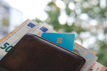 brown leather wallet with EU Currency banknotes with Bank card, cash money from European Union in...