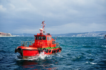 Tugboat - Rescue red vessel on a cruise at sea