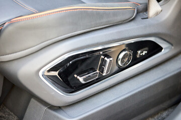 Car detail seat adjustment control panel close up view. Adjustable car seat position. Car interior.