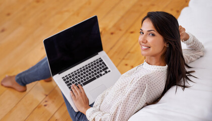 Woman, home and laptop on sofa, confident and lounge for portrait, smile and confidence in remote...