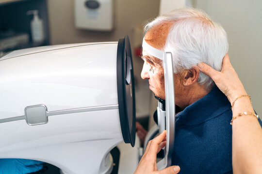Healthcare professional assists in a delicate laser glaucoma procedure.
