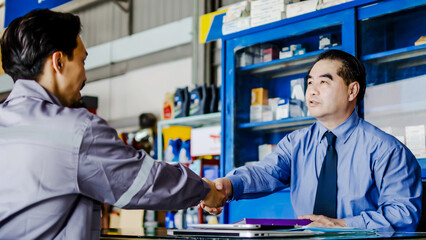 Asian mechanic repairman pass job interview sit in front of Business man answers questions shake...