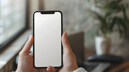 Man using smartphone blank screen frameless modern design while lying on the sofa in home interior