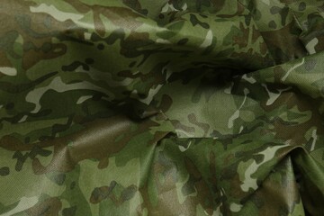 Texture of crumpled camouflage fabric as background, top view